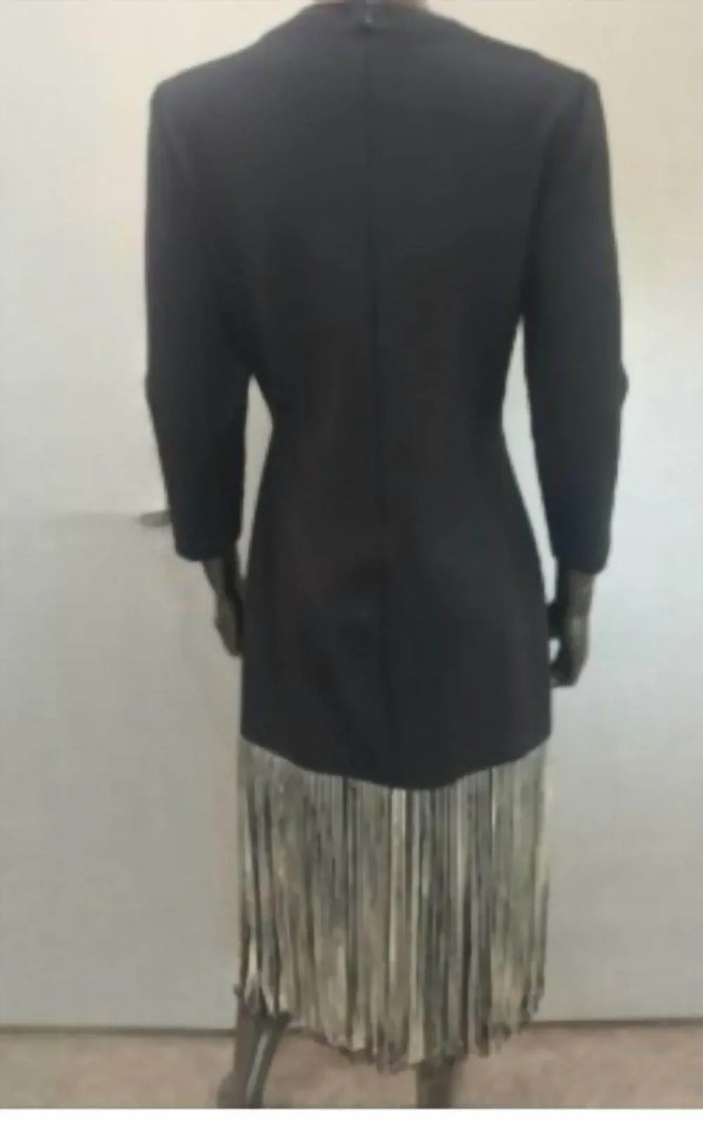 Black dress with black and white fringes at the bottom